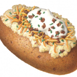 Baked potato with the works: butter, sour cream, chives, cheddar cheese and bacon bits
