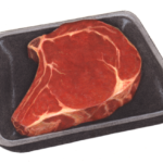 Uncooked beef rib steak on a black foam container.